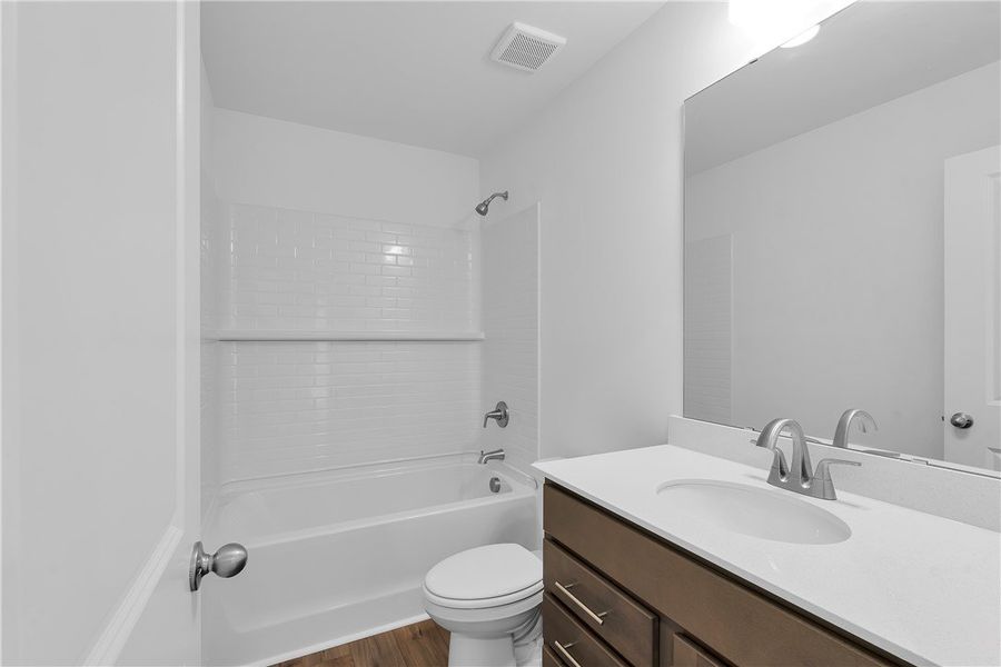 Bright and clean bathroom featuring a full bathtub