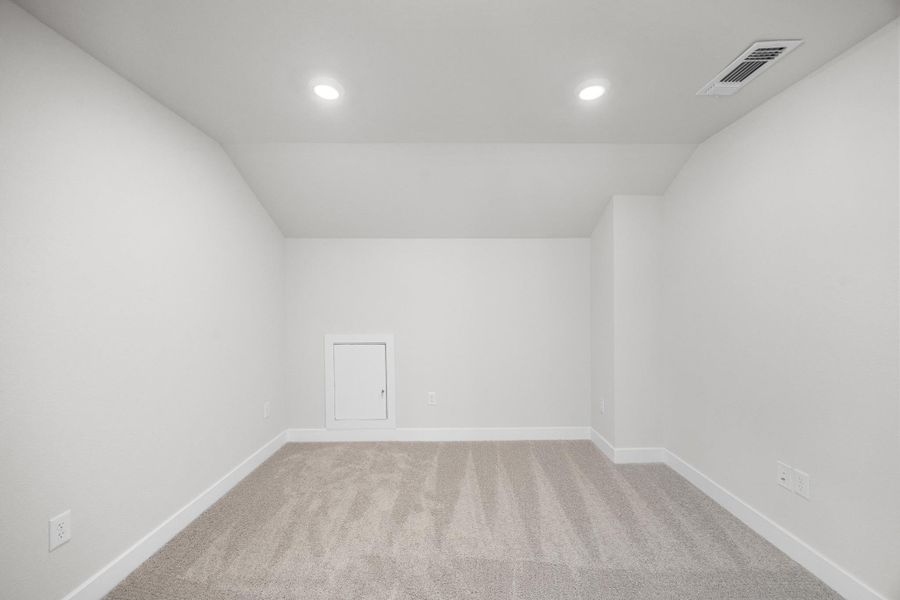 Additional living space with vaulted ceiling, carpet, and recessed lighting