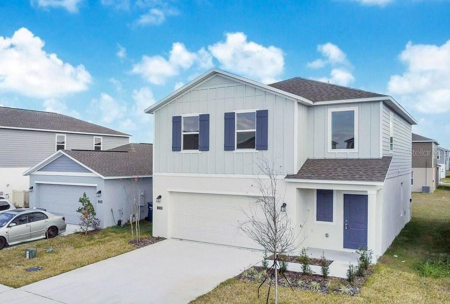 Front exterior of a new home in Peace Creek Reserve, Winter Haven, FL, highlighting curb appeal (Image 14).