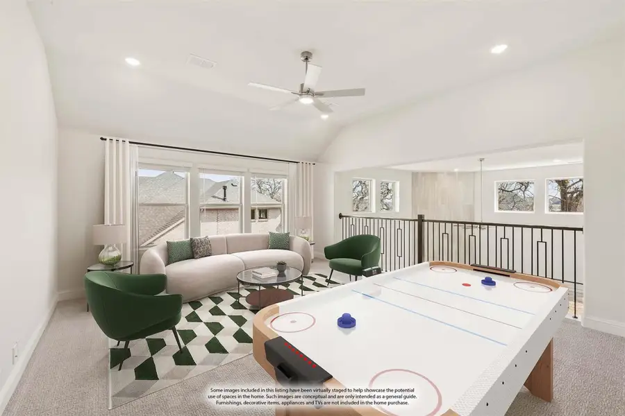 Upstairs game room with air hockey table, seating area, vaulted ceiling, and open stair railing
