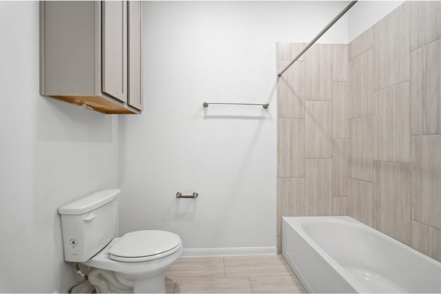 Full bath featuring toilet and tub / shower combination