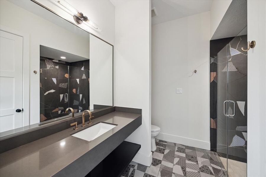 Each bathroom in this home features its own custom color tile, creating a unique and stunning visual experience. From vibrant blues to serene earth tones, the carefully selected tiles add a personalized touch to each space. The custom designs not only enhance the aesthetic appeal but also reflect a distinct character, making every bathroom a one-of-a-kind retreat.