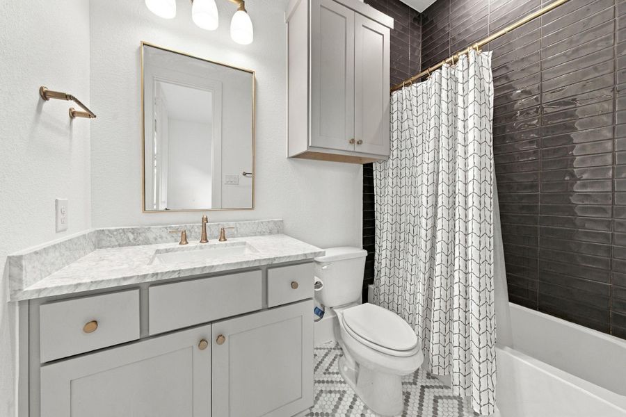Secondary bathroom attached directly to one of the secondary bedrooms.
