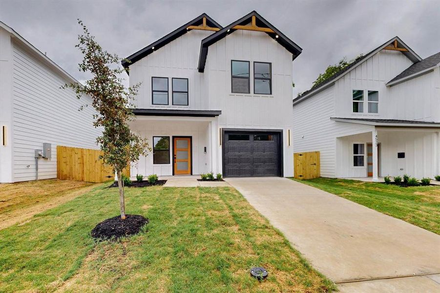 Modern farmhouse featuring board and batten siding, driveway, and an attached garage Modern farmhouse featuring board and batten siding, driveway, and an attached garage