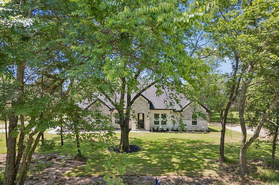 So many mature trees in the front of the home.