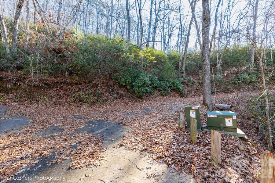 End of the pavement and underground electric boxes.  Main build site is to the right, upper build site is to the left.