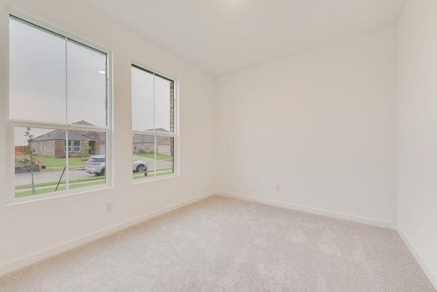 Empty room with light colored carpet and baseboards Empty room with light colored carpet and baseboards