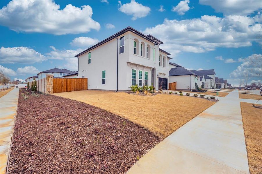 View of home's exterior featuring a residential view, stucco siding, and fence