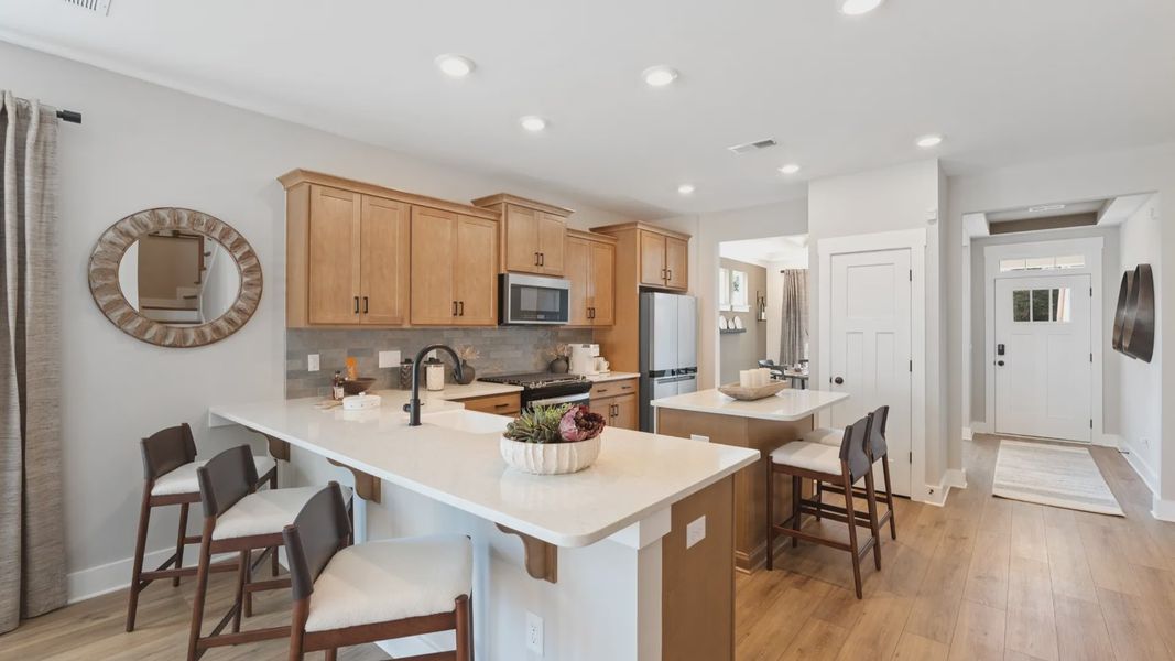 Beautifully appointed kitchen with spacious counters and sophisticated detailing at the new Barton Hollow community