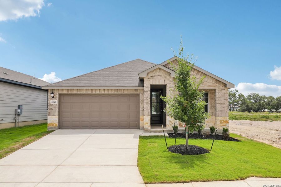 Front exterior of a new home in Thomas Pond, San Antonio, TX, highlighting curb appeal (Image 2). Front exterior of a new home in Thomas Pond, San Antonio, TX, highlighting curb appeal (Image 2).