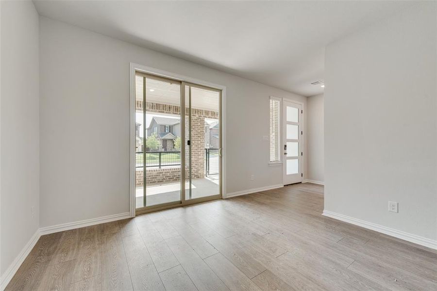 Empty room featuring light hardwood / wood-style floors and a wealth of natural light