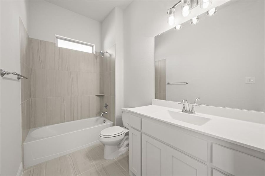 Secondary Full bathroom with tile patterned floors, vanity, toilet, and bathing tub / shower combination