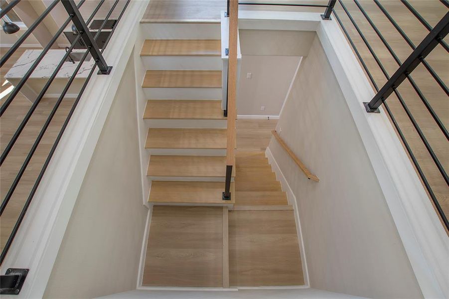 Staircase with hardwood / wood-style flooring