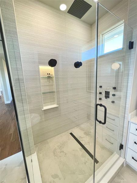 Master bath with a shower stall and vanity