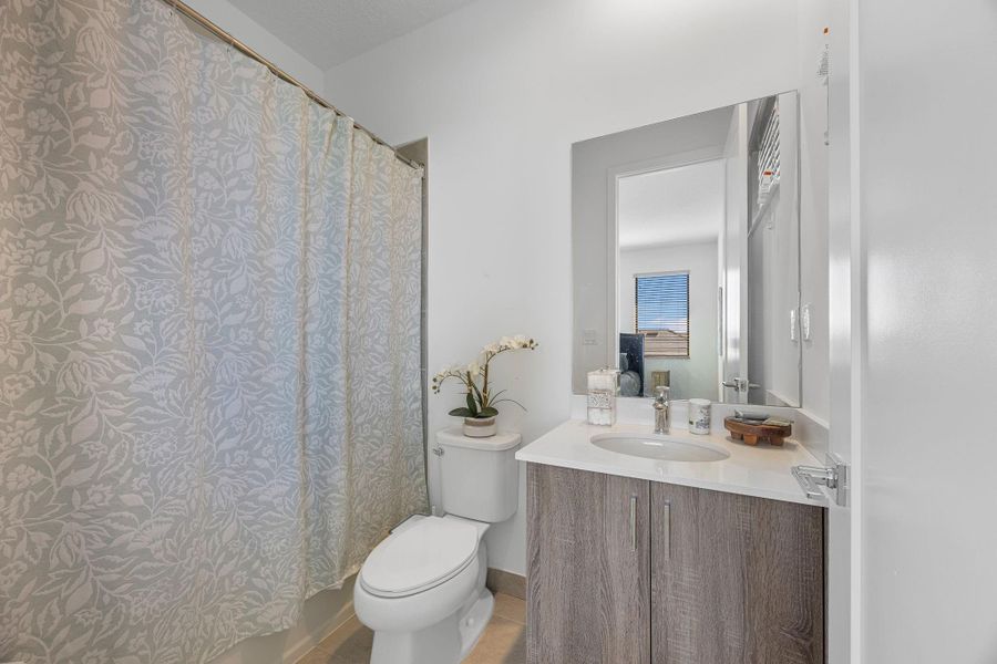 Bathroom with vanity and light tile patterned floors