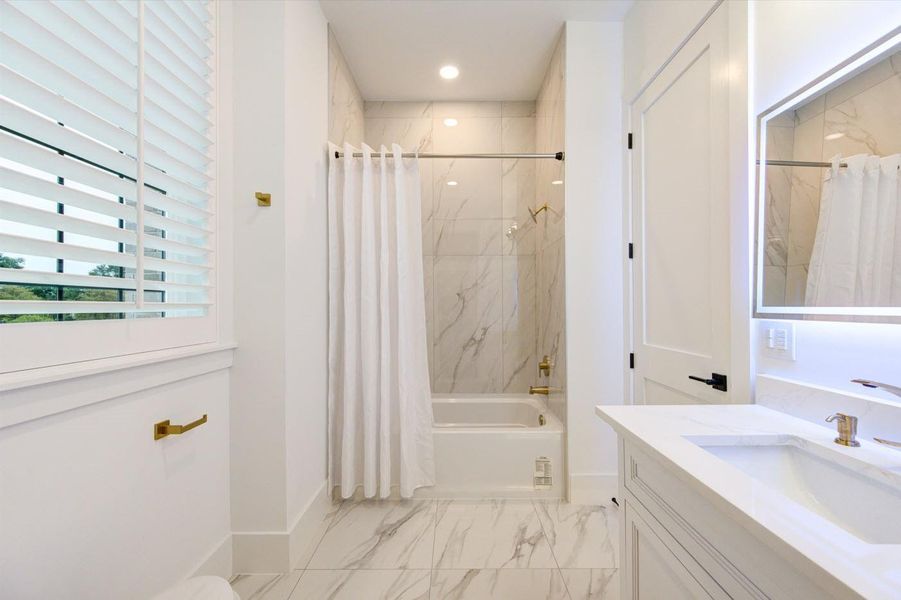 Bathroom #2 on 2nd flooor. Each bathroom features LED mirror, timer for exhaust fan and floor to ceiling tiling.