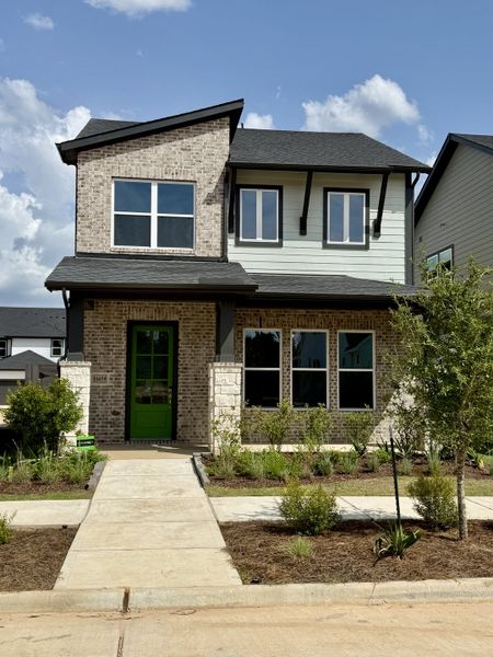 Front exterior of a new home in Two Step Farm - Cottages Row Collection, Montgomery, TX, highlighting curb appeal (Image 21). Front exterior of a new home in Two Step Farm - Cottages Row Collection, Montgomery, TX, highlighting curb appeal (Image 21).