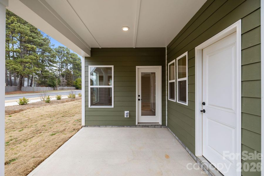 Covered rear patio with entrance to family room and separate mudroom entrance