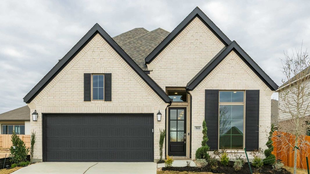 Front exterior of a new home in Lariat 45', Liberty Hill, TX, highlighting curb appeal (Image 1). Front exterior of a new home in Lariat 45', Liberty Hill, TX, highlighting curb appeal (Image 1).