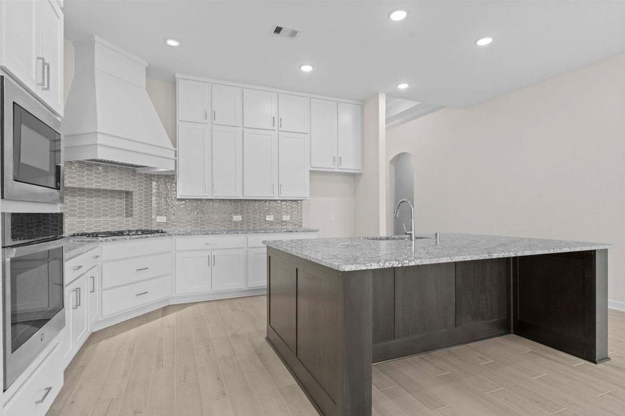 Another perspective of the gourmet kitchen showcasing the open-concept design and elegant cabinetry, creating the ultimate heart of the home.