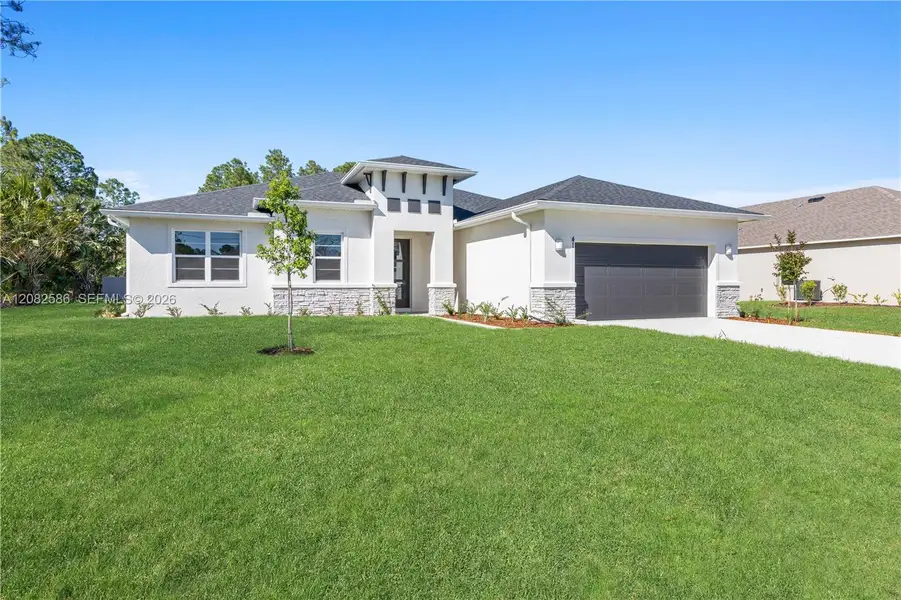 Front exterior of a new home in , Palm Bay, FL, highlighting curb appeal (Image 1). Front exterior of a new home in , Palm Bay, FL, highlighting curb appeal (Image 1).