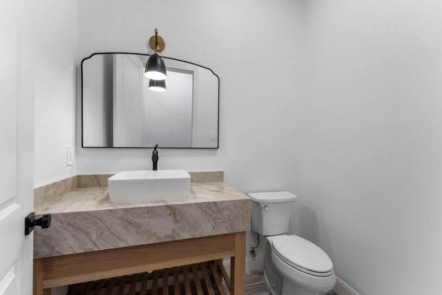 Powder room conveniently located downstairs.