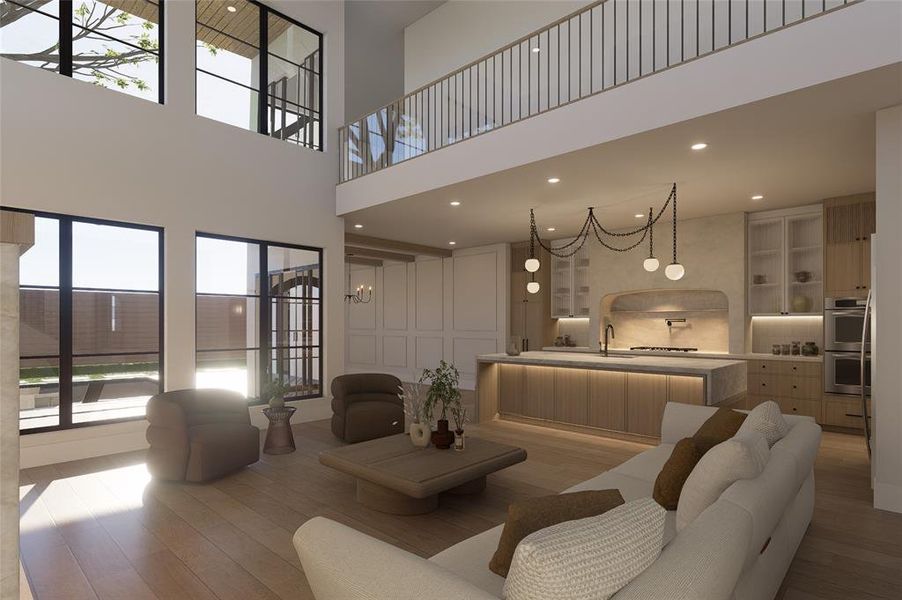 Living area with a high ceiling, light wood-style flooring, and recessed lighting