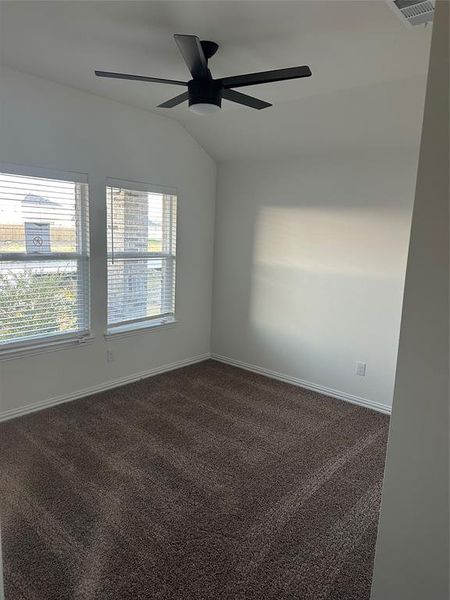 Spare room featuringt, lofted ceiling, and ceiling fan