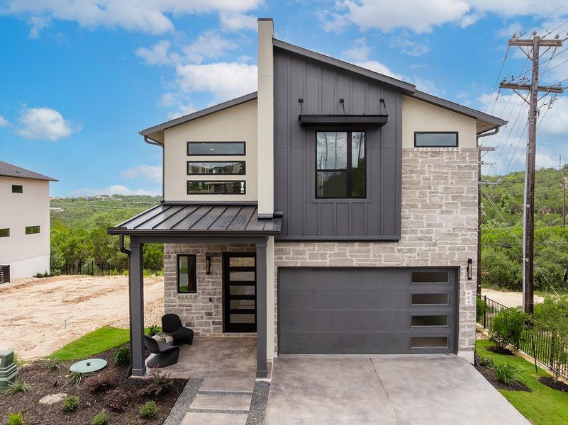 This home is a Drees Foxglove plan, stone, stucco and hardy plank exterior with metal roof and 2 car garage
