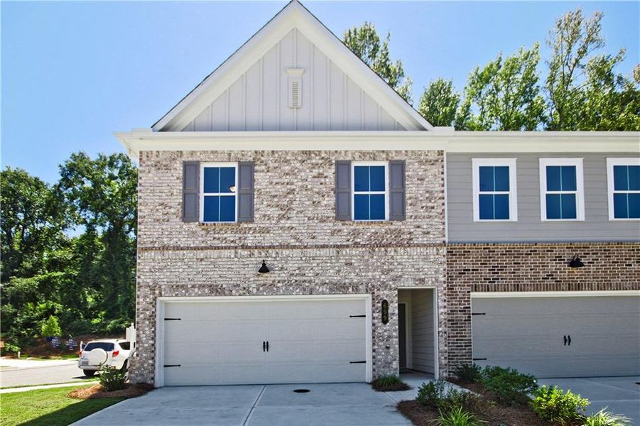 Front exterior of a new home in River Walk Place, Lawrenceville, GA, highlighting curb appeal (Image 1).