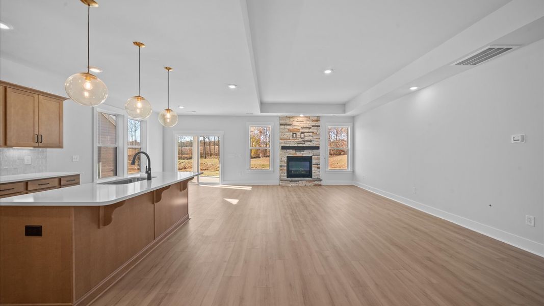 Spacious family room with rich hardwood flooring and elegant trim work in a reputable DRB Homes build