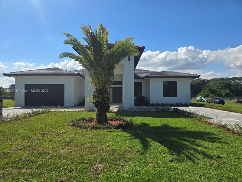 Front exterior of a new home in , Homestead, FL, highlighting curb appeal (Image 40).
