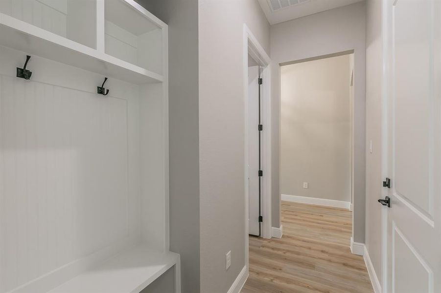 Mudroom featuring light wood-type flooring and baseboards Mudroom featuring light wood-type flooring and baseboards