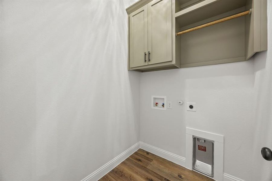 Laundry room with gas dryer hookup, dark wood-style floors, washer hookup, cabinet space, and electric dryer hookup Laundry room with gas dryer hookup, dark wood-style floors, washer hookup, cabinet space, and electric dryer hookup