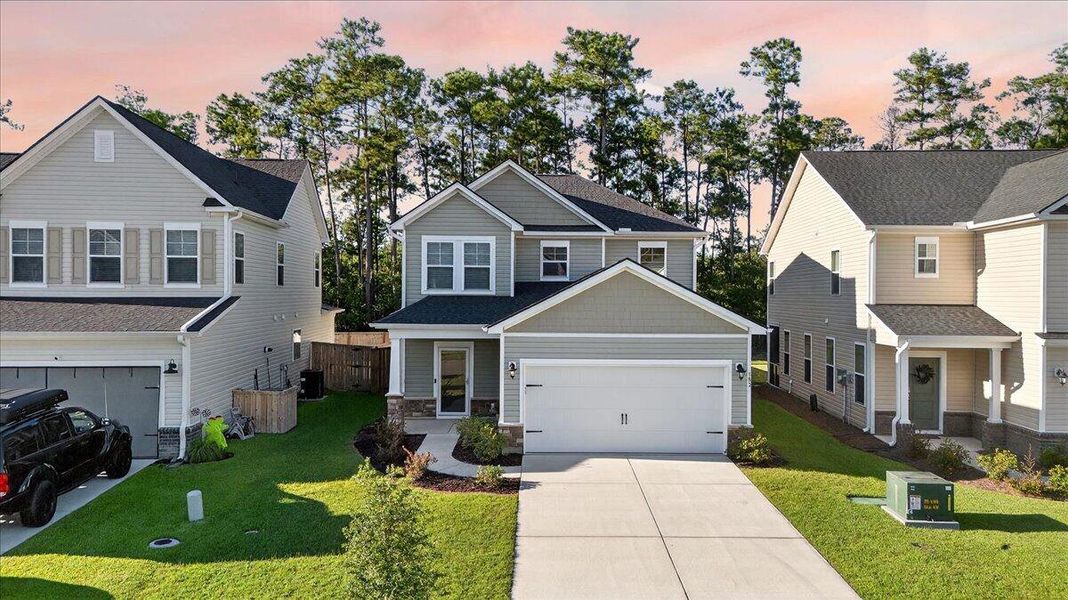 Front exterior of a new home in Jasmine Point at Lakes of Cane Bay, Summerville, SC, highlighting curb appeal (Image 20).