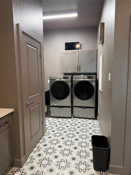 Spacious laundry room with ample storage and room for modern appliances.