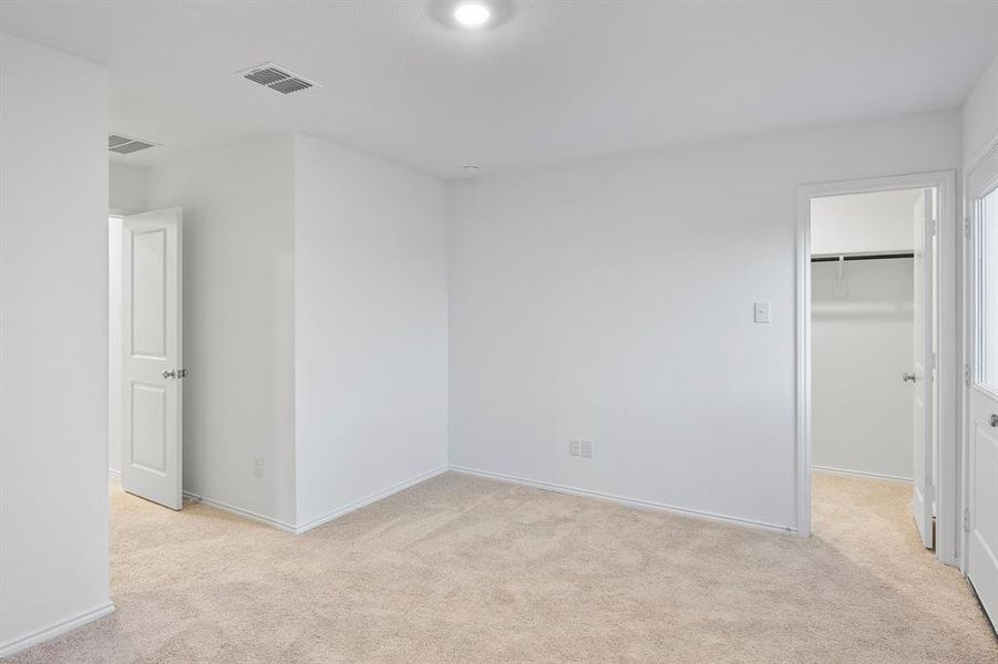 Empty room featuring light colored carpet