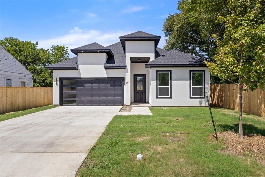 View of front of property featuring a shingled roof, concrete driveway, stucco siding, and an attached garage View of front of property featuring a shingled roof, concrete driveway, stucco siding, and an attached garage