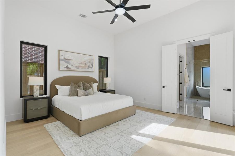 Vaulted ceilings enhance this space featuring light wood-finish flooring and a contemporary black ceiling fan Vaulted ceilings enhance this space featuring light wood-finish flooring and a contemporary black ceiling fan