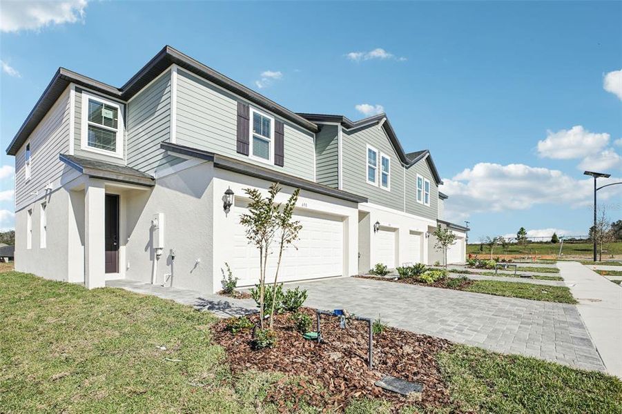 Front exterior of a new home in , Lady Lake, FL, highlighting curb appeal (Image 24).