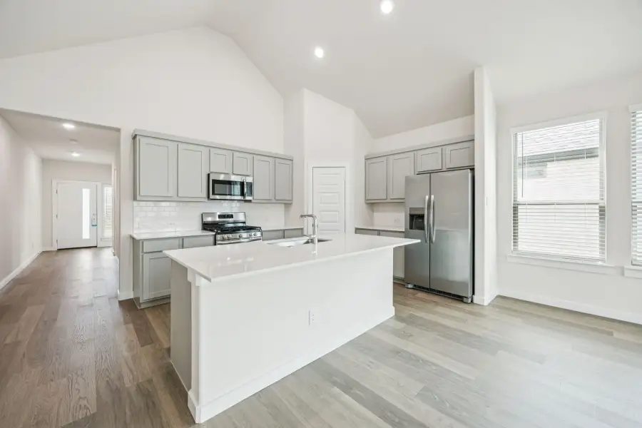 Kitchen in the Claret home plan by Trophy Signature Homes – REPRESENTATIVE PHOTO