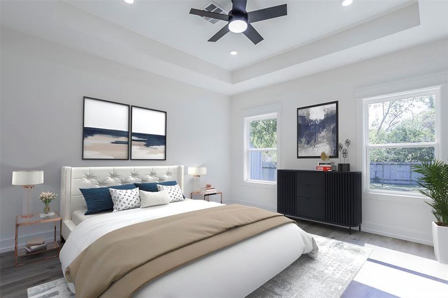 Spacious bedroom featuring a tray ceiling with recessed lighting and a ceiling fan - virtual staging