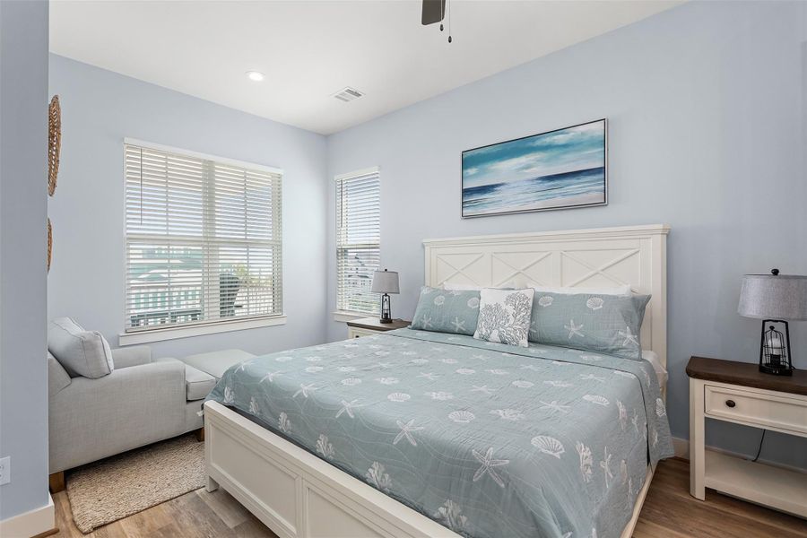 The second-floor Primary Suite is a private haven, offering abundant space, soothing finishes, and access to Gulf breezes for the ultimate coastal retreat.