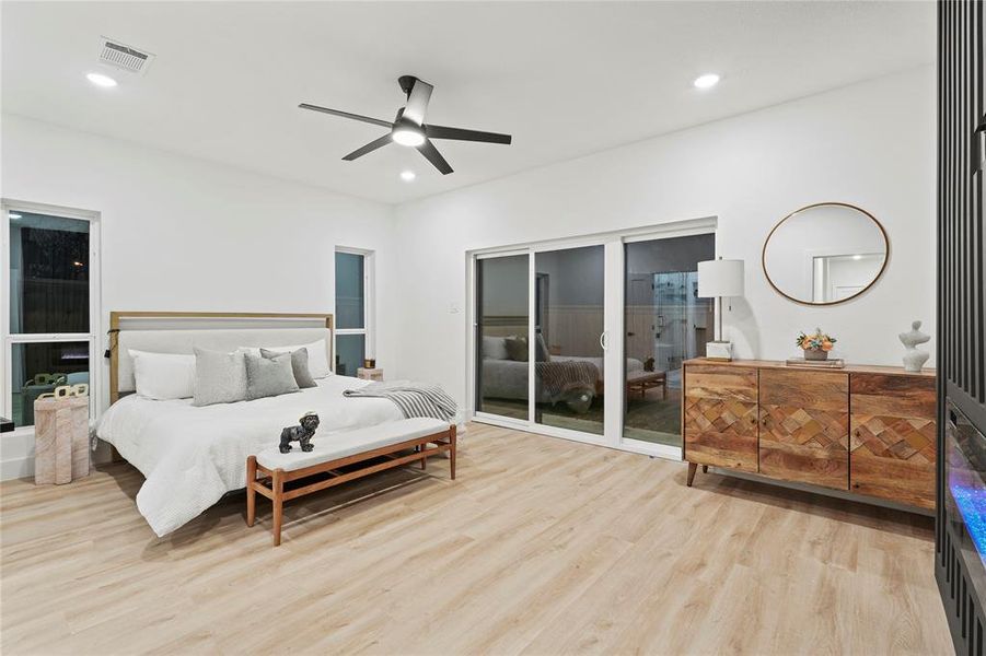 Bedroom featuring light wood-style floors, ceiling fan, access to exterior, and recessed lighting Bedroom featuring light wood-style floors, ceiling fan, access to exterior, and recessed lighting