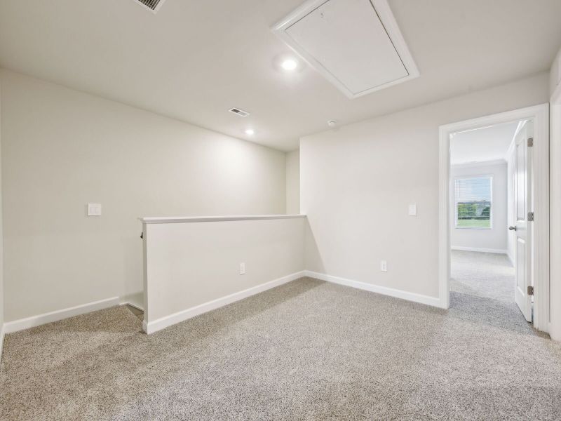 An upstairs loft can be easily transformed into a work area or home theater.