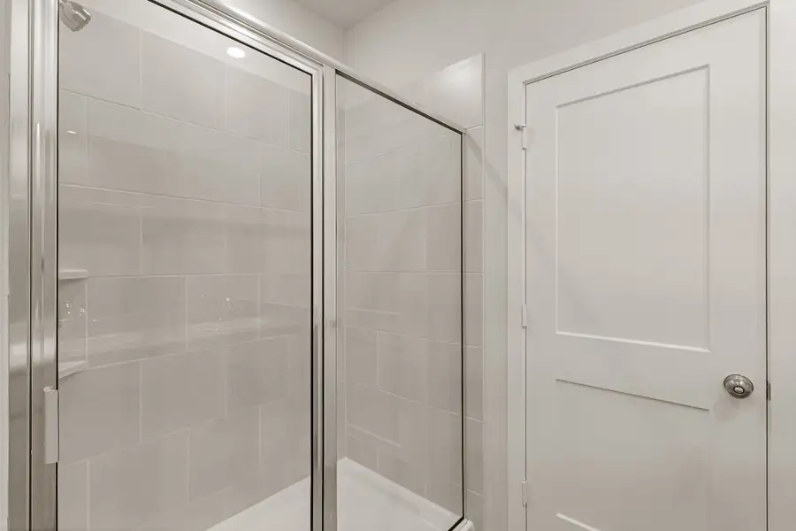 A shower with a glass door.