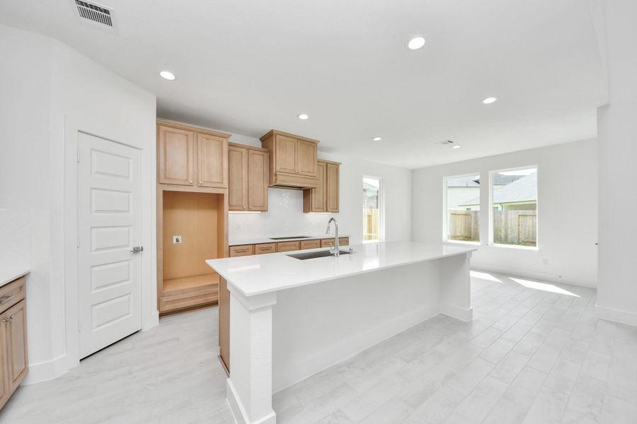 The kitchen is a culinary haven, featuring granite countertops, a tile backsplash, stainless steel appliances, 42” upper cabinets, and undercabinet lighting. The kitchen is a culinary haven, featuring granite countertops, a tile backsplash, stainless steel appliances, 42” upper cabinets, and undercabinet lighting.
