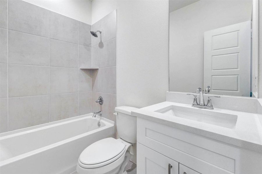 This full bathroom includes a clean white vanity, sleek countertop, chrome fixtures, and a tub/shower combination with neutral tile surround. The built-in shower niche adds function, while the bright finishes keep the space feeling fresh, simple, and move-in ready. This full bathroom includes a clean white vanity, sleek countertop, chrome fixtures, and a tub/shower combination with neutral tile surround. The built-in shower niche adds function, while the bright finishes keep the space feeling fresh, simple, and move-in ready.