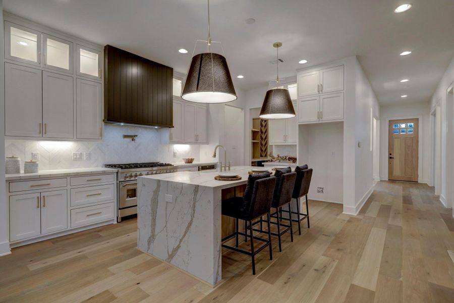 Plenty of seating at the island*photos are of a previously constructed home by the builder. 1527 Hewitt may have different selections at builders sole discretion. These photos are not meant to be an exact representation of 1527 Hewitt.