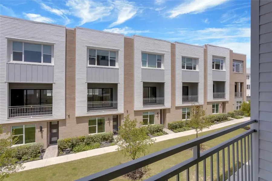 These modern townhomes feature private balconies, sleek exterior finishes, and meticulously maintained grounds.